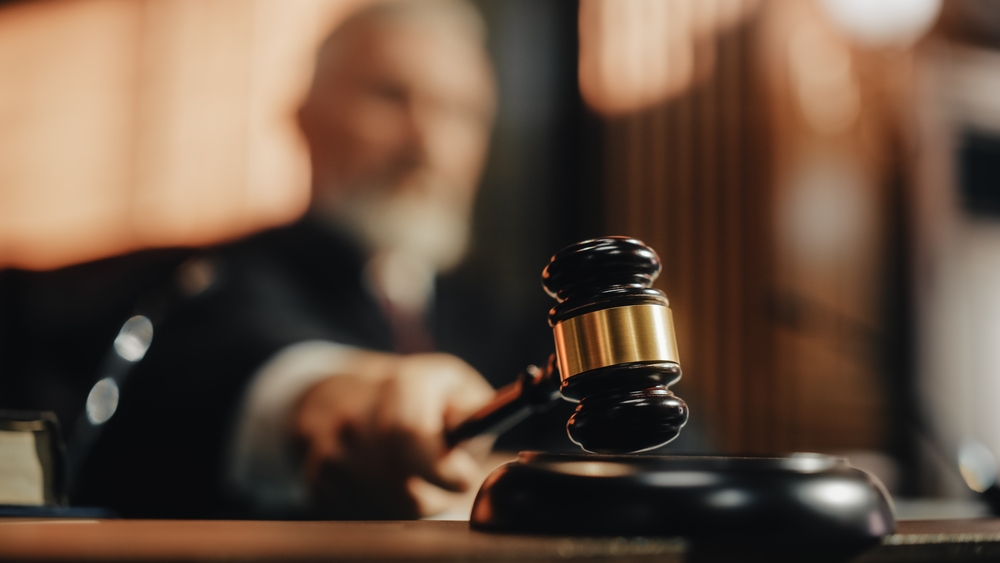 Judge holding a gavel in a courtroom